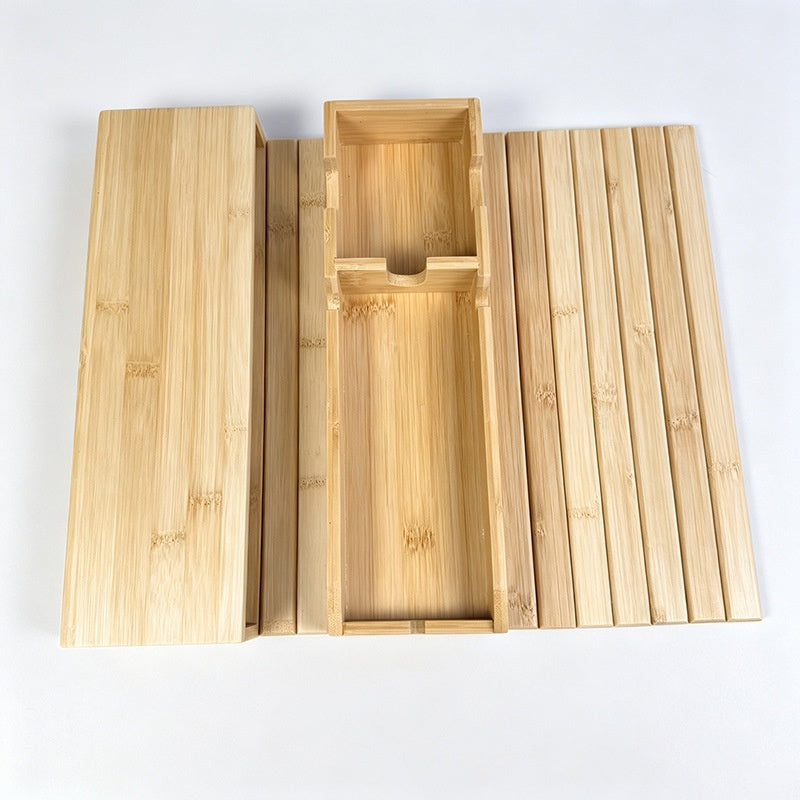 Large bamboo couch-arm tray with built-in cup holder and phone slot on a white background